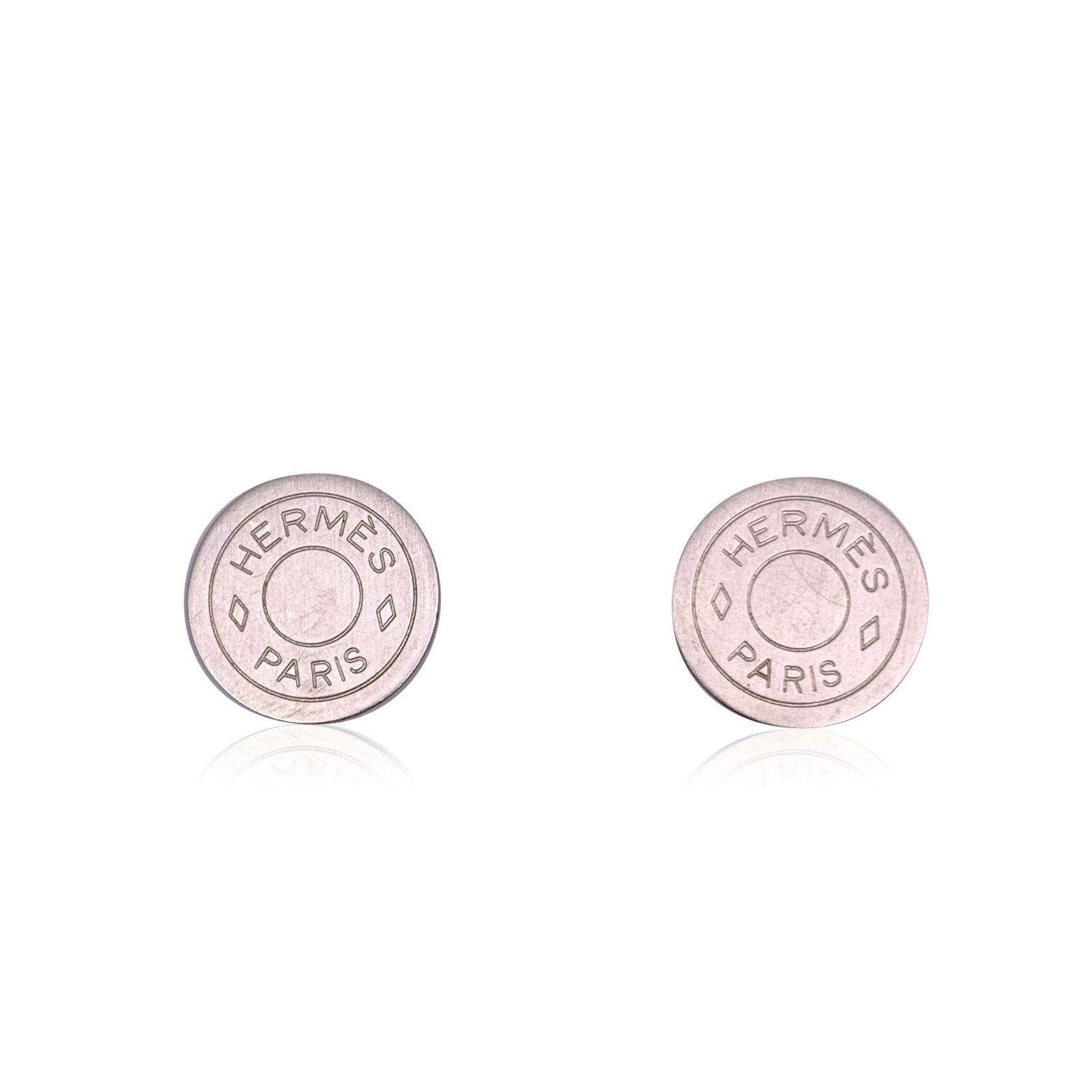 HERMES METAL EARRINGS CLOU DE SELLE: Discover the understated elegance of these vintage Hermes silver metal round 'Clou de Selle' clip-on earrings. With a sleek and minimalist design, these 20mm diameter earrings feature the iconic Clou 