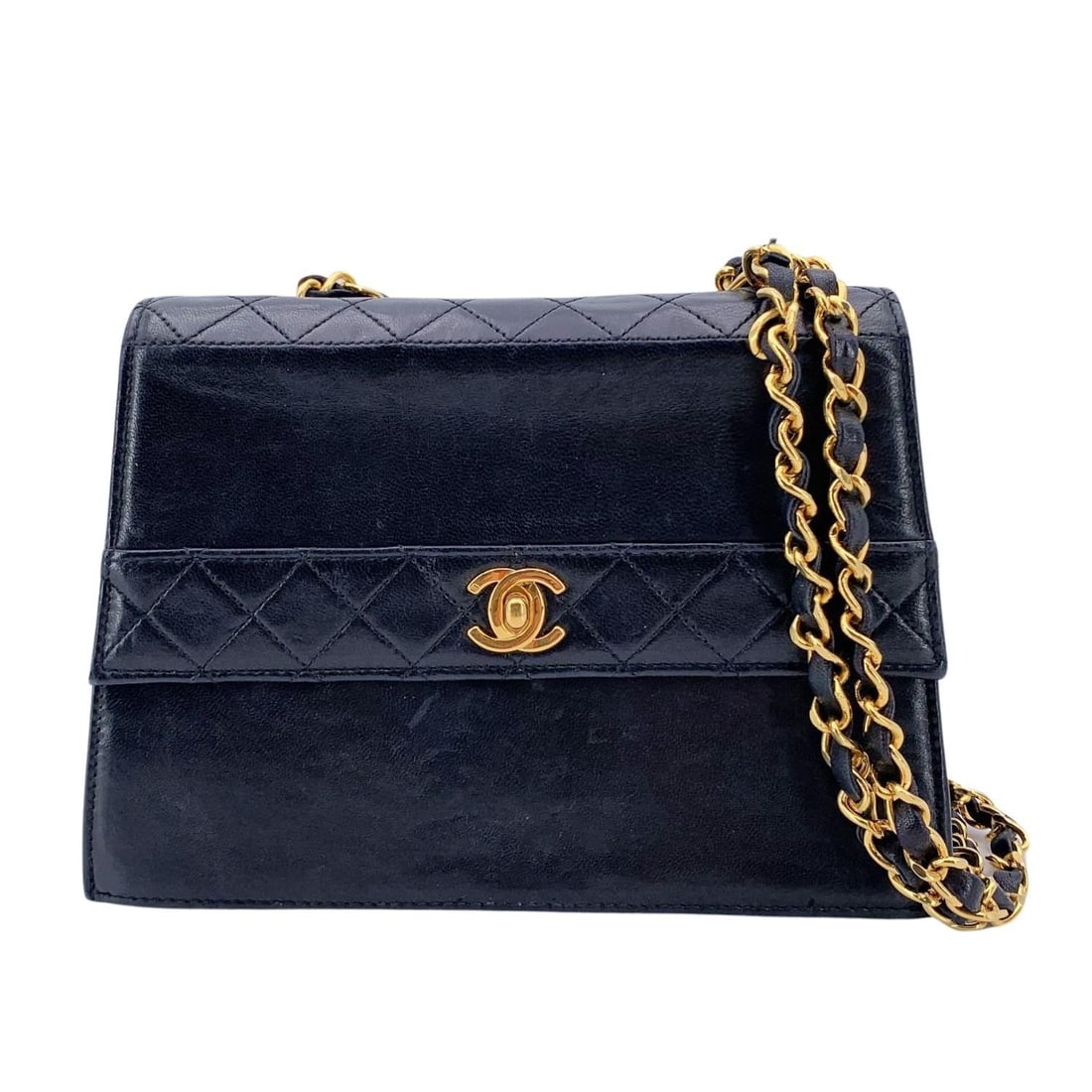 CHANEL VINTAGE LEATHER CROSSBODY BAG TRAPEZIO: Vintage Chanel crossbody bag in black leather with Quilted leather trim. Structured design. Period/Era: 1989-1991. Flap with CC turn lock closure. Burgundy leather lining. 1 side pocket with button