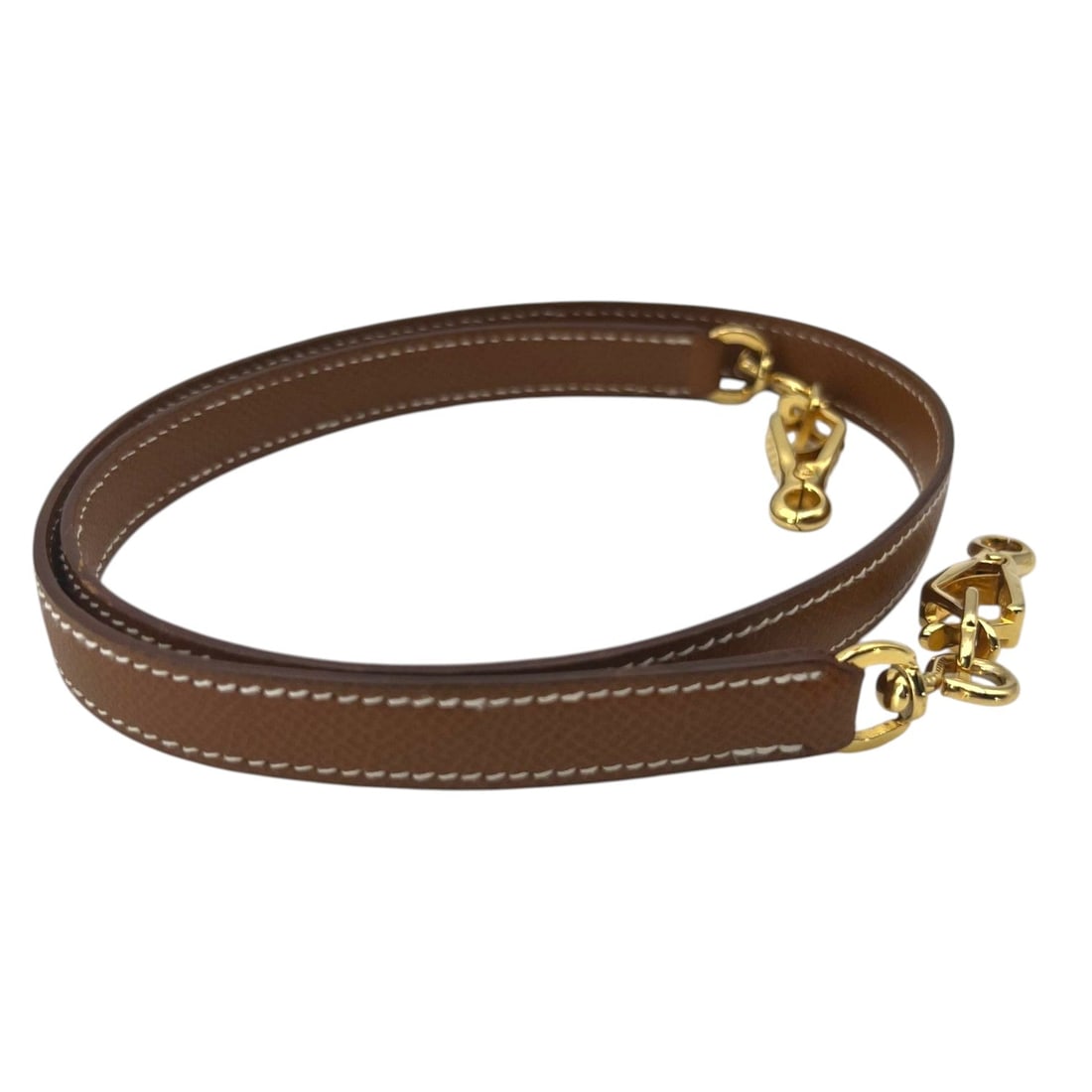 HERMES LEATHER SHOULDER BAG SHOULDER STRAP FOR KELLY BAG: Enhance your iconic Kelly Bag with this Hermes vintage shoulder strap, a rare find for any dedicated second-hand connoisseur. Crafted in France, this 33 cm accessory is made from premium tan leather i