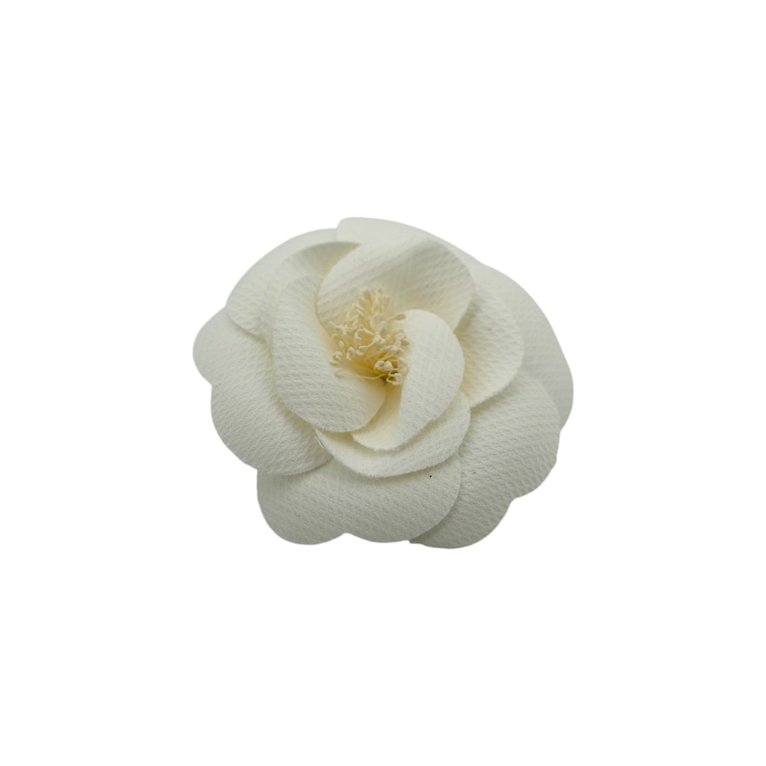 CHANEL CLOTH BROOCH CAMELIA: Step into the world of Parisian elegance with this stunning Chanel Camelia brooch, an iconic symbol of the house's storied heritage. Crafted in France between 2000 and 2009, this exquisite white cloth