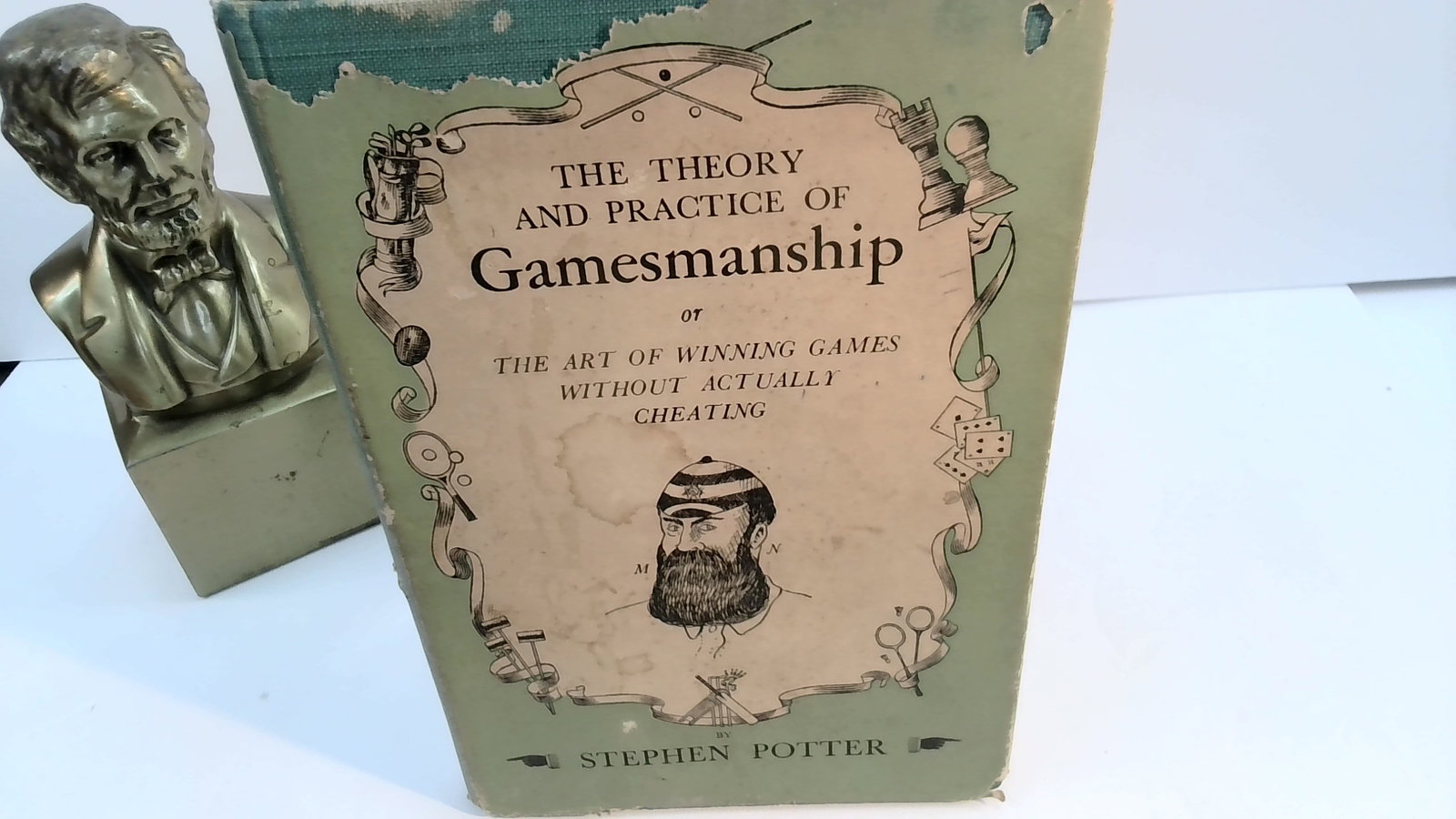Theory and Practice of Gamesmanship by Stephen Potter 1953: Published by Rupert Hart Davis , London, in jacket, jacket with some small edge rips with some limited blemish book is sound ,strong hinges.