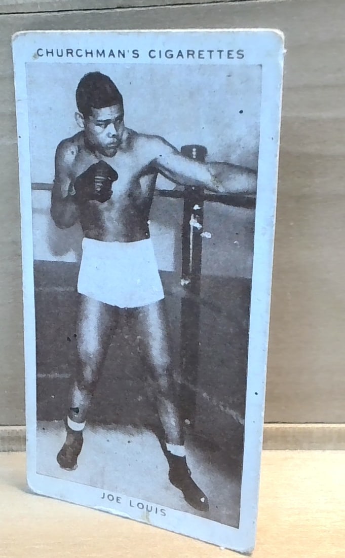 1938 Original Boxing Personalities Tobacco card Joe Louis #26 VG+-F: Part of the original 1938 Churchman Boxing Personalities Tobacco cards Series, , an unusual card great for grading ,or for collecting or reselling. Card comes in penny sleave and hard plastic top load
