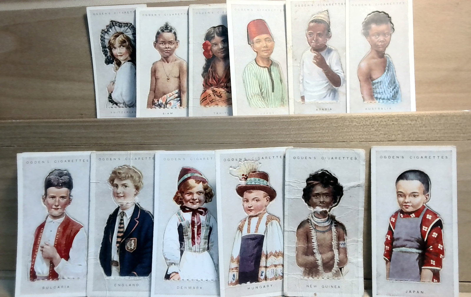 Tobacco cards lot 1924 Ogdens Children of All Nations 14 cards lot VG-VG+: nice lot, in VG condition. Original card(s) great for grading ,or for collecting or reselling. Many original tobacco cards, sets, singles, collections and part sets available. We are happy to combine 