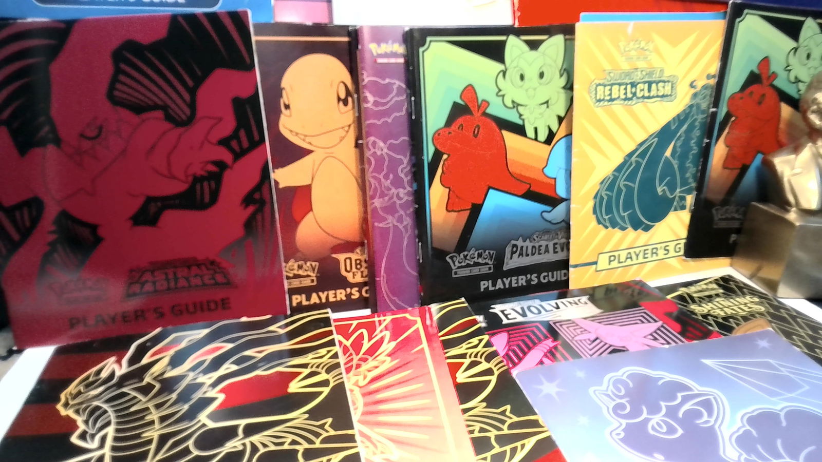 Large stack of Pokemon Players Guides: Most from 2020-2023 , majority in very good condition of few with some wear but overall good, some duplication, 32 guides. all are sturdy and bright.