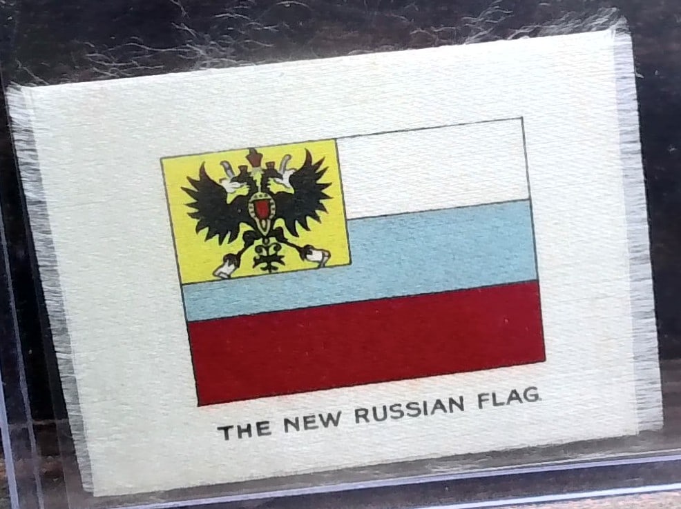 1912 German Tobacco card - The New Russian Flag Silk: with some rear card surface wear, Many Tobacco cards and silks available. Consistently adding new items daily to our Auction. Please keep checking back for new arrivals. Please note any white specks i