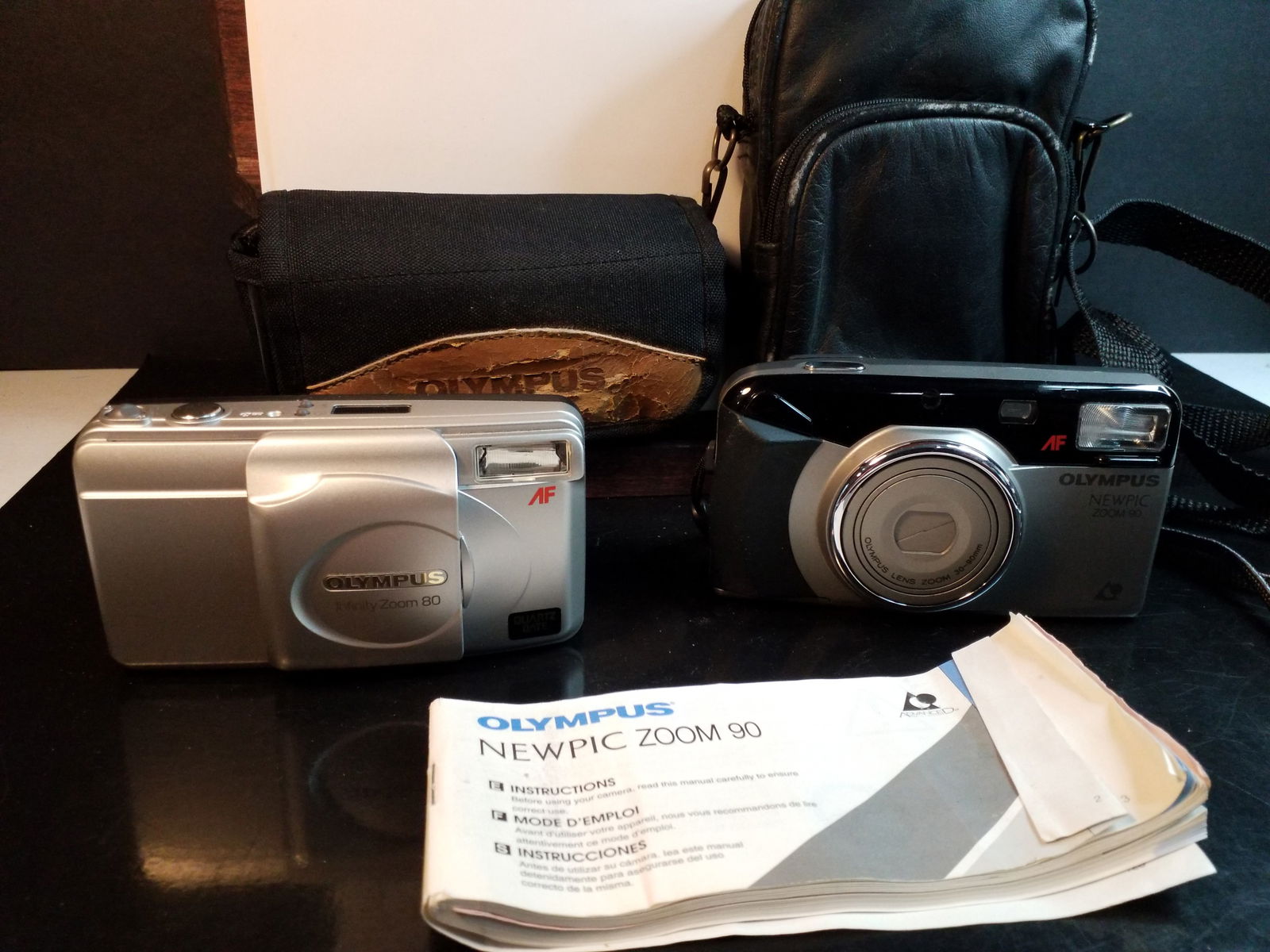 2 Olympus Camera with cases: in Good condition, unknown working condition, most likely working, please view photos.