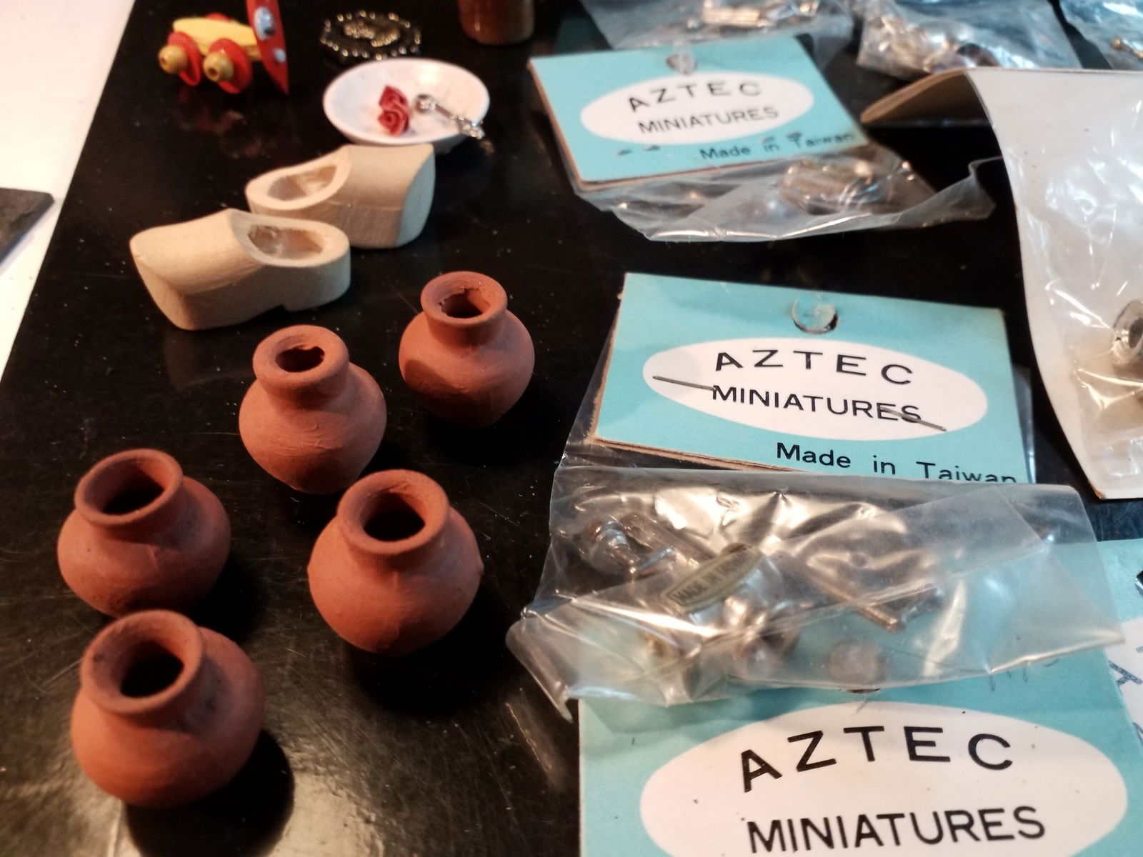 Large Rare Vintage Collection of Aztec and Designland Craft Minuatures Doll house accessories: Many pieces still in original packaging made in Taiwan. Vintage collection of miniature collectible primarily doll house type accessories, table settings, clay pots, toasters, etc. Lots of interesting