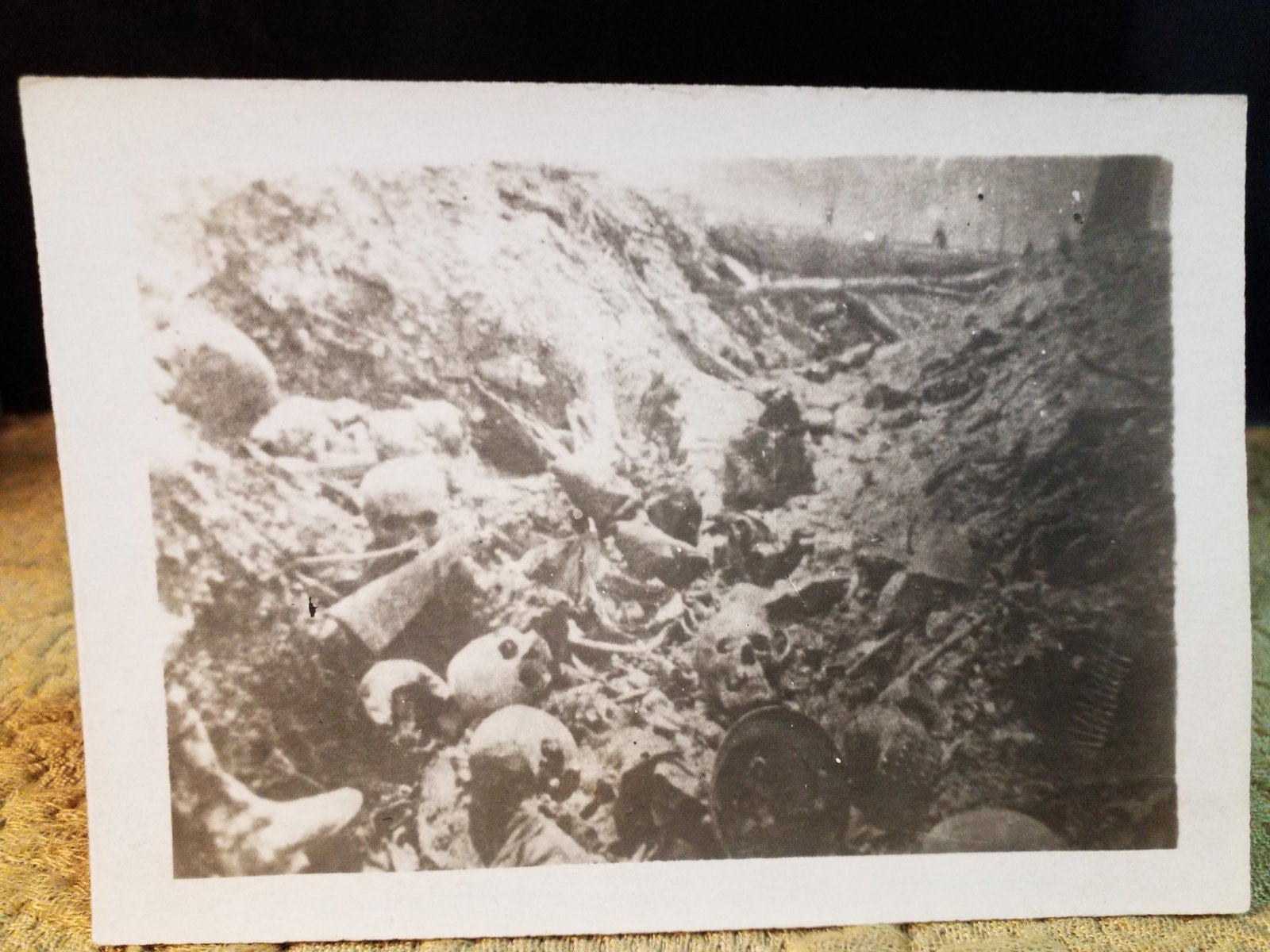Original WWI RPPC Real Photo Postcard Tragic trench grave of Casualties of war Skulls bones etc. (1 of 2)