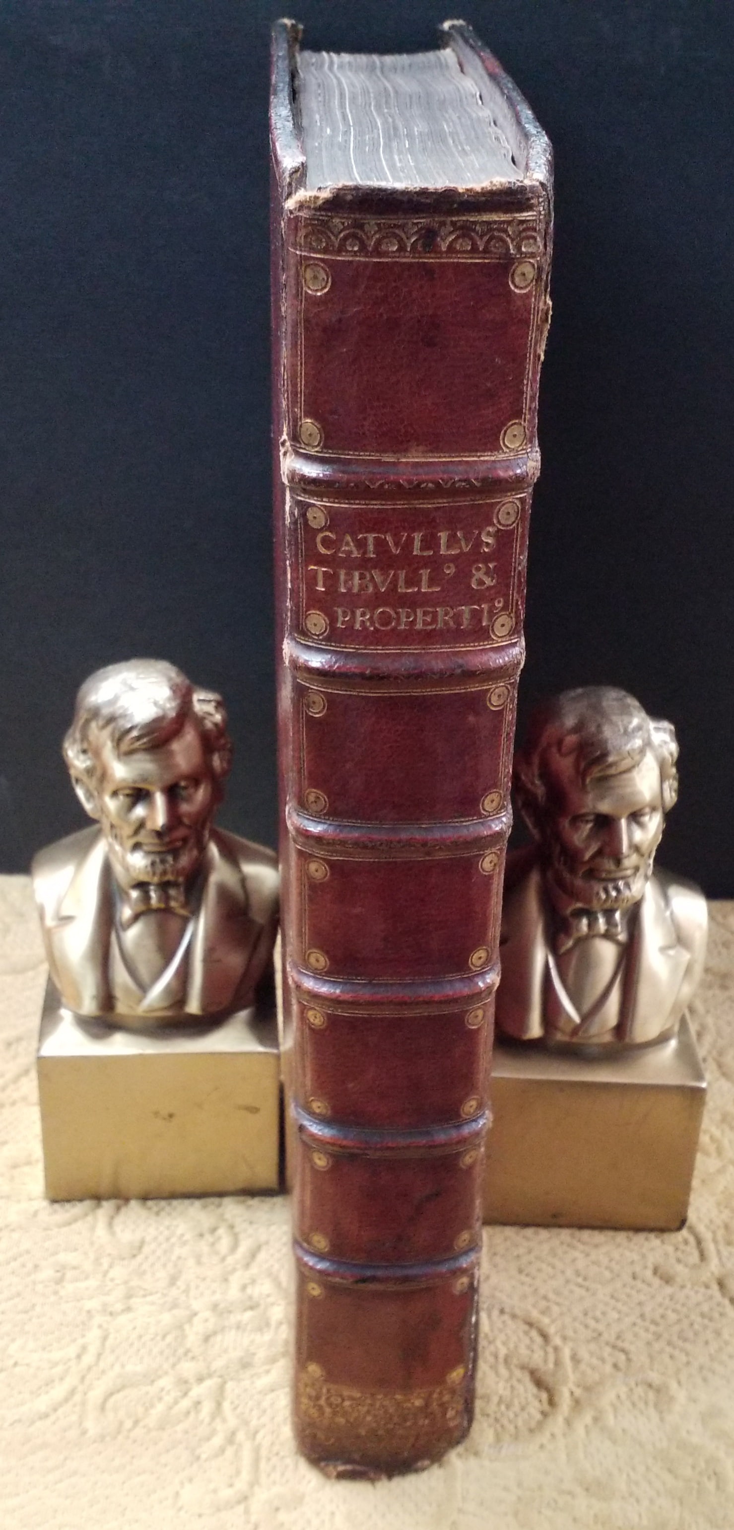 1702 The Works of Catullus, Tibullus, and Propertius , Famous Roman Poets with Rare Foredge Painting: Foredge Painting. Also Known as Peekaboo pictures or vanishing pictures. on the one side is an English Castle and other is an English Village with a cathedral Possibly Westminster Cathedral. A Spectac