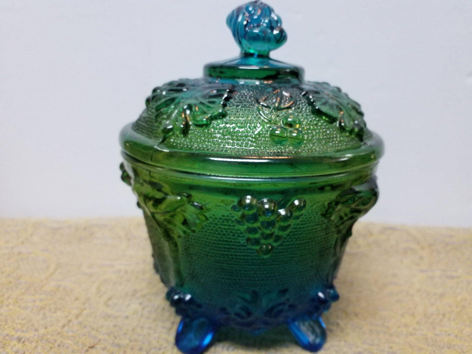 Jeanette Glass 3525 Footed Covered Candy Dish Blue Green Grapes & Leaves in original package: In original package, Stunning Candy Dish. measures approx. 6 inches tall by 4 inches width. Beautiful piece.