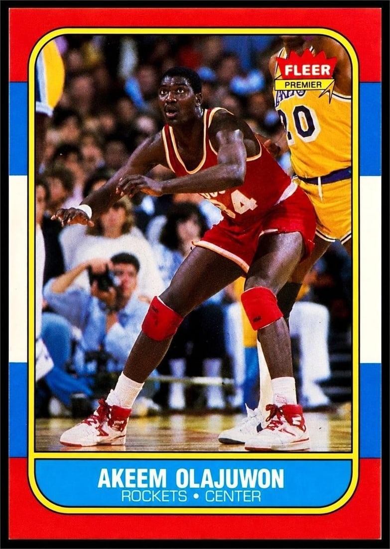 1986 Fleer #82 Akeem Olajuwon NBA Rookie: 1986 Fleer #82 Akeem Olajuwon NBA Rookie Basketball Trading Card. One of the premier Hall of Fame rookie cards from the legendary 1986 Fleer basketball set and an essential early collectible of one of