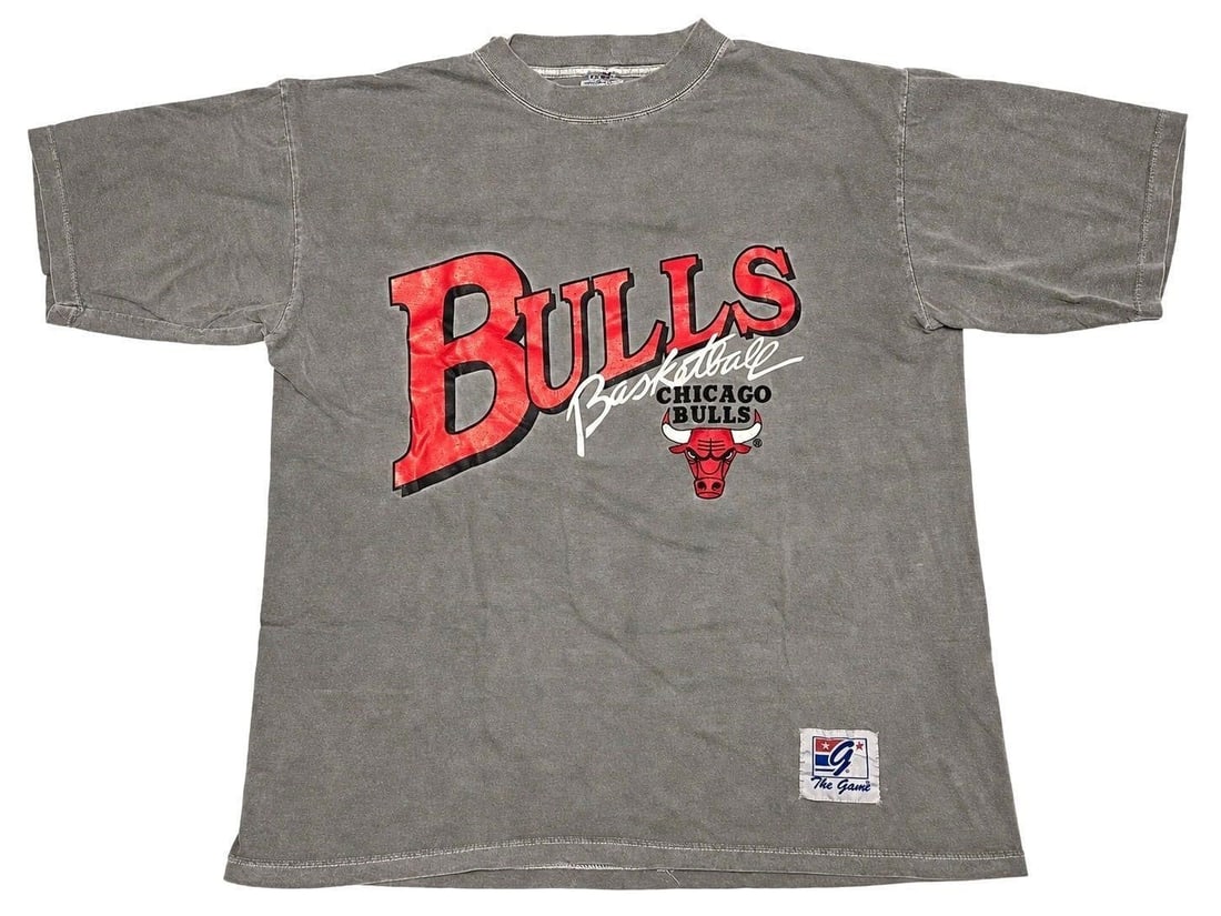 The Game Chicago Bulls Basketball T-Shirt (L): The Game Chicago Bulls Basketball T-Shirt (Size L). A striking piece of period Bulls apparel featuring the oversized graphic style that became synonymous with basketball fashion during the Michael Jor