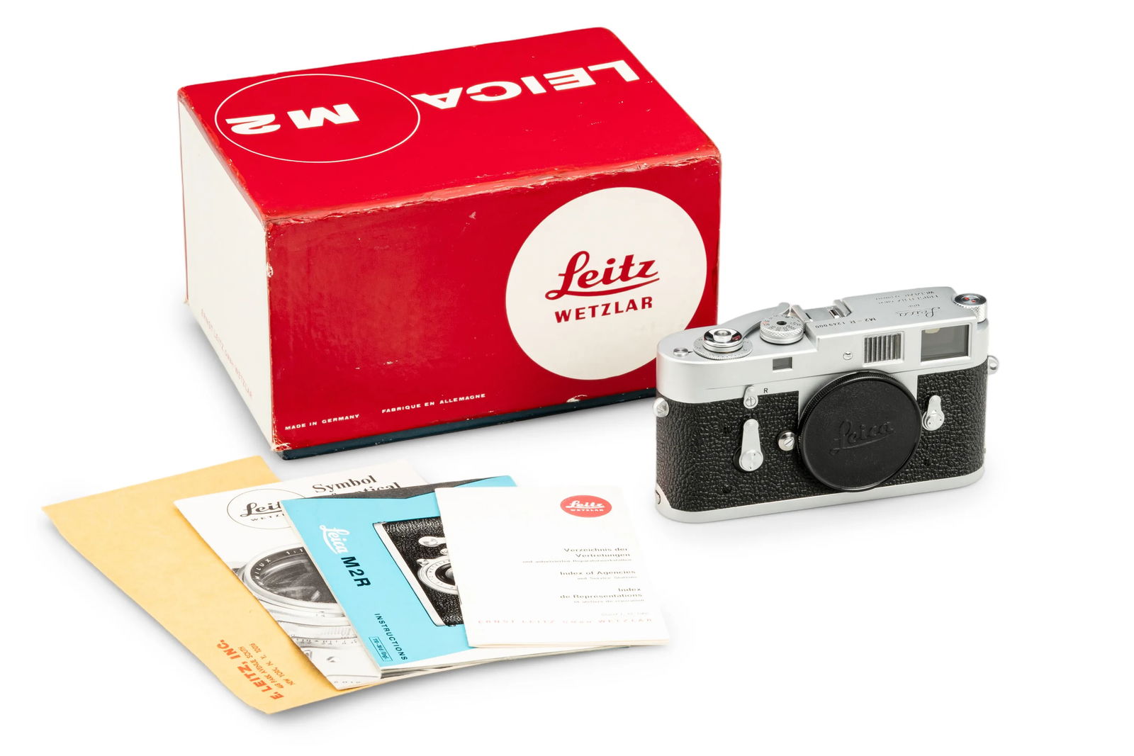 Leica M2-R Chrome: A rare Leica M2-R featuring the quick-loading system inherited from the Leica M4. The camera is in like new condition and perfect working order. This lot is complete with the maker's box with matching