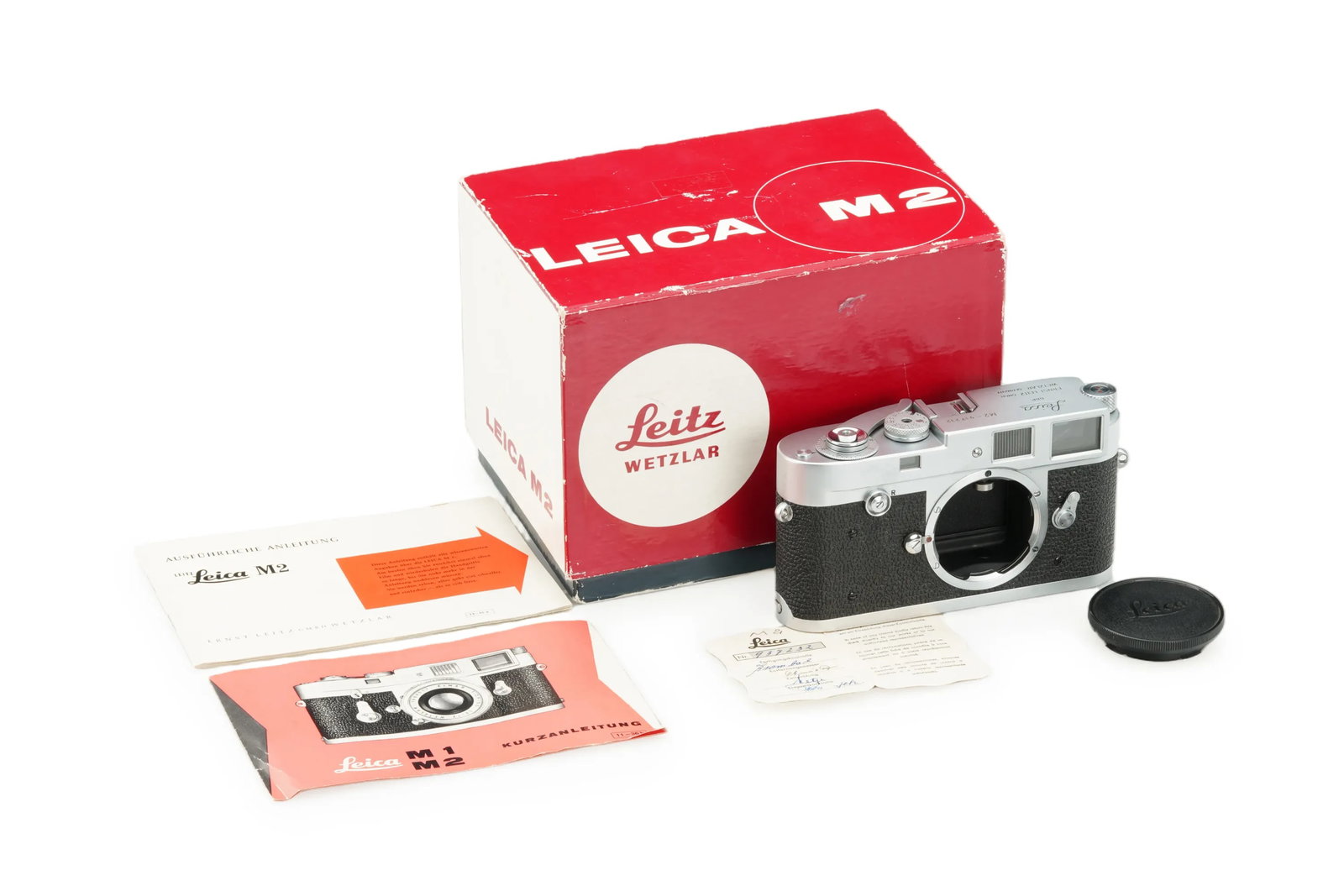 Leica M2 Chrome: This first-version Leica M2 features the classic button rewind system without a self-timer, presented in near-mint condition and full working order. It is accompanied by its original control tag,