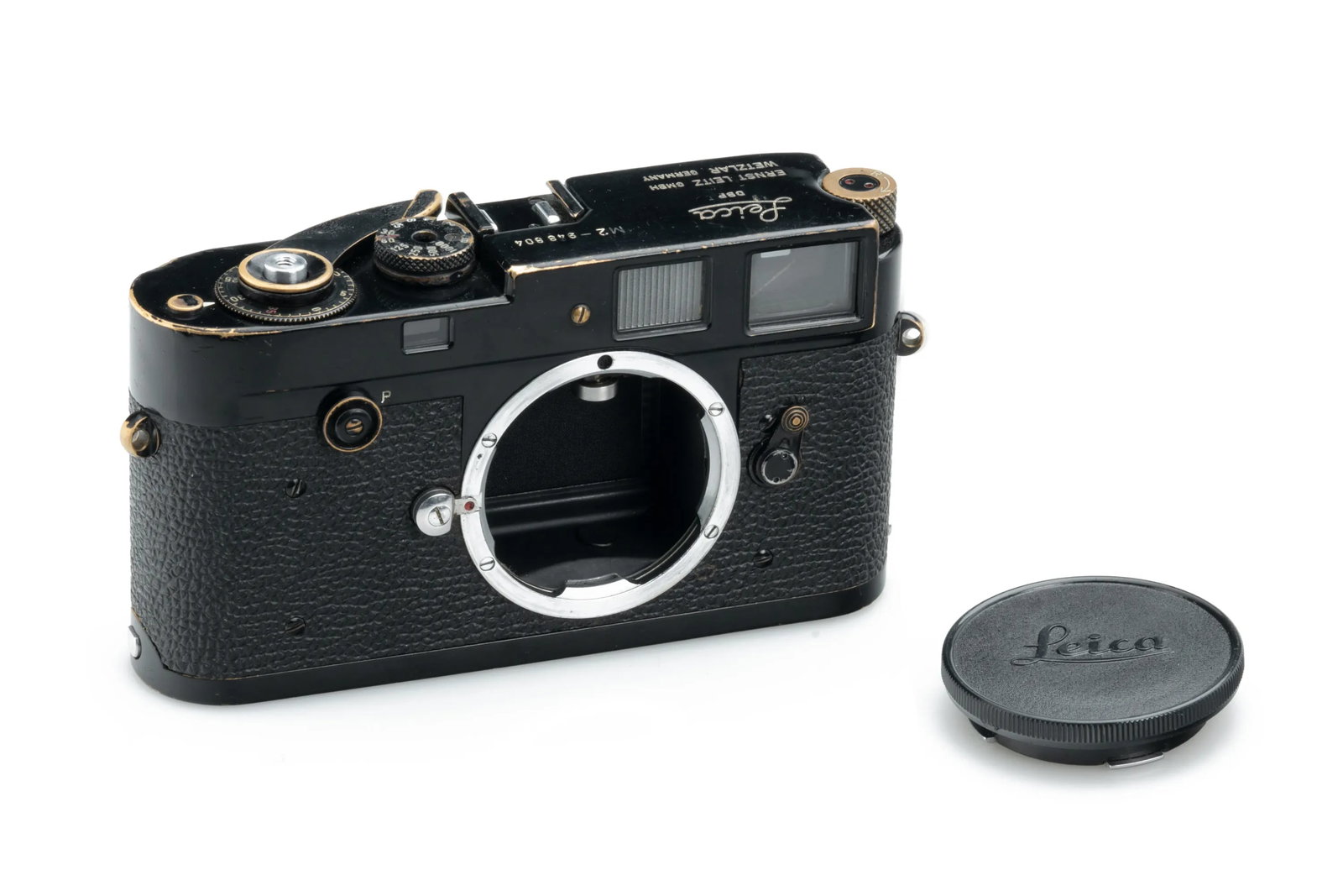 Leica M2 Black Paint Button: An early and sought-after Leica M2 in original black paint, featuring the classic button rewind knob, remains in good working order. The body displays a visible patina along the edges, revealing the b