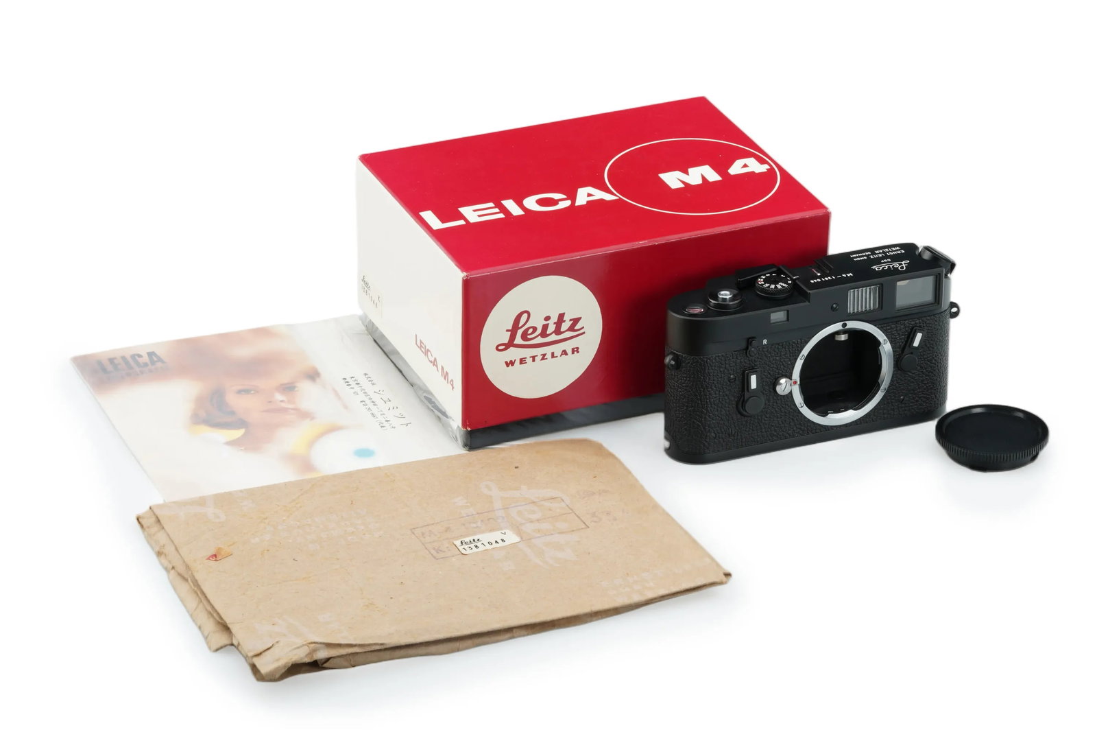 Leica M4 Black Chrome: A Leica M4 in black chrome finish, presented in mint condition and perfect working order. The camera comes with its original wrapping paper and maker's box.