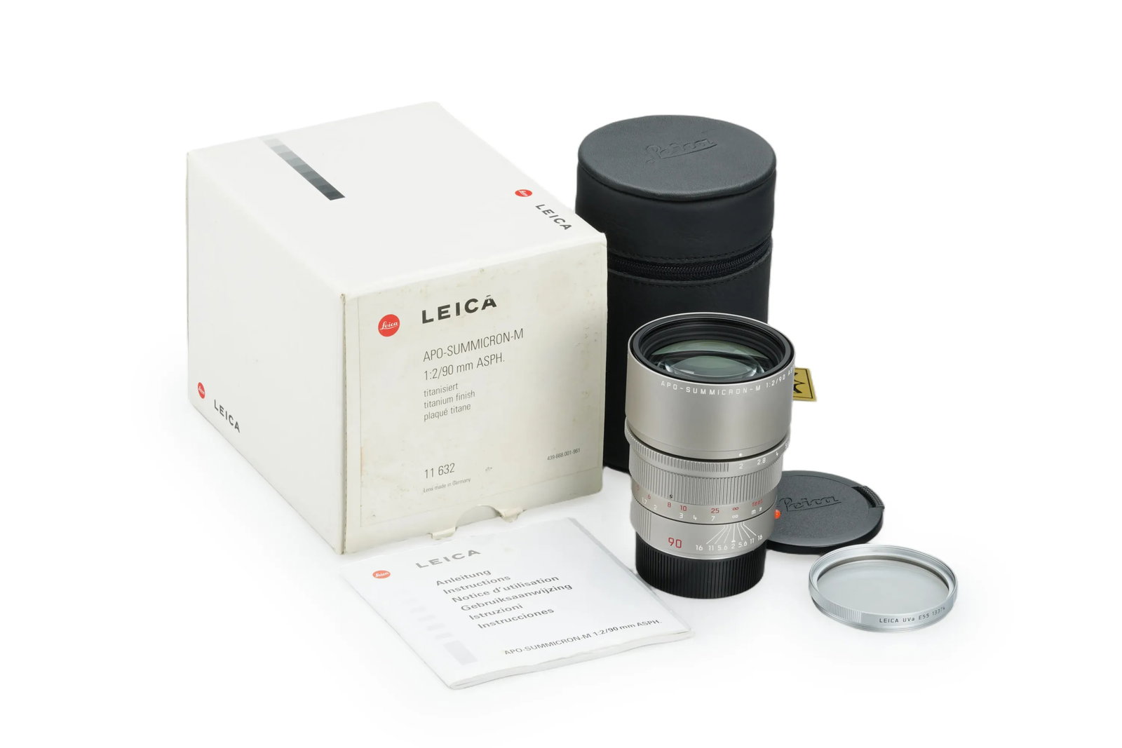 Leica APO-Summicron-M 2/90mm ASPH. Titan 11632: A rare titanium-finish APO Summicron 2/90mm ASPH. lens is in mint condition with clean optics. This lot is complete with a silver filter, both lens caps, a leather keeper, the warranty card, and the