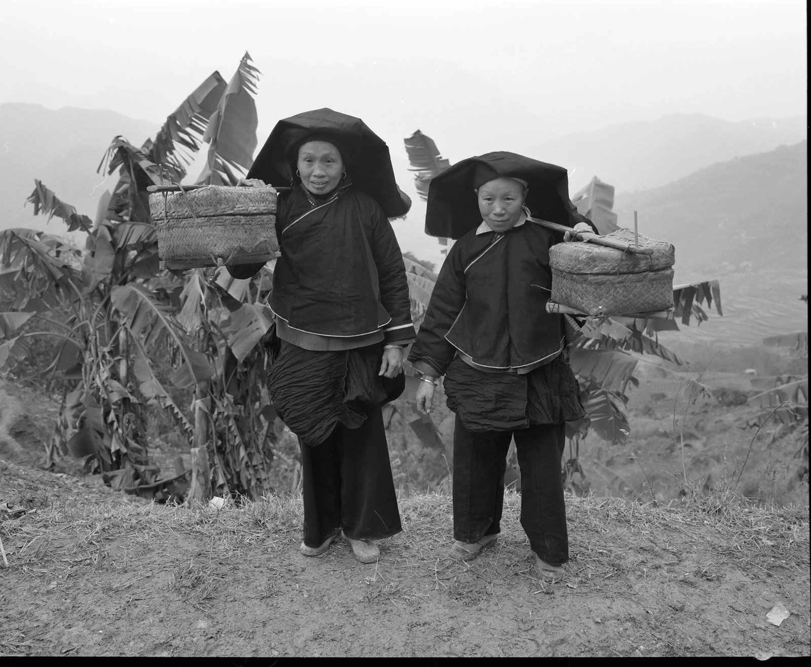 Black-Clad Zhuang Women Visiting Relatives in Guangxi: Location: Napo County, Guangxi Zhuang Autonomous Region Medium: Gelatin silver print Edition: 1/8 Signature: Signed by the artist This work was photographed in 2010 deep in the mountains of Napo
