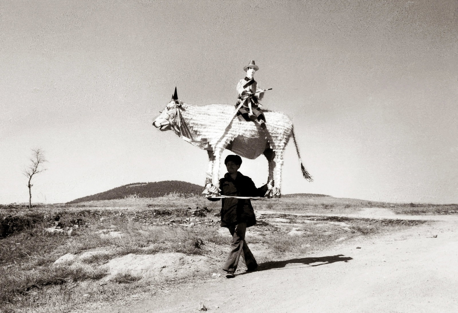 Humanism in China, No. 559: Creation Date: 2001 Location: Linyi, Shandong Technique: Digital giclee print Edition: 1/5 Signature: Signed by the artist Caption: A man carrying sacrificial offerings is walking alone in the
