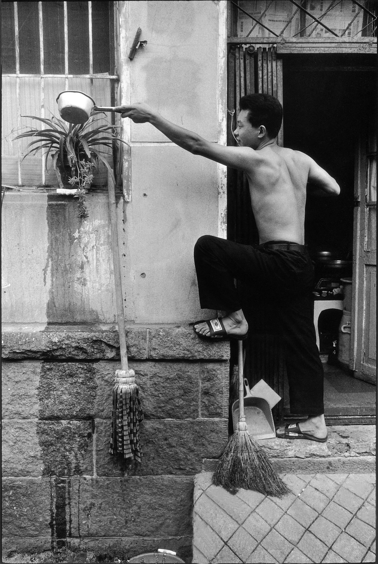 No. 10 Courtyard Series: Series:Humanism in China, No. 477-4 Caption: A Young Man Watering Flowers Camera: Leica M6 with 28mm lens Medium: Digital giclee print Edition: 1/8 + 2 AP Signature: Signed by the artist This work