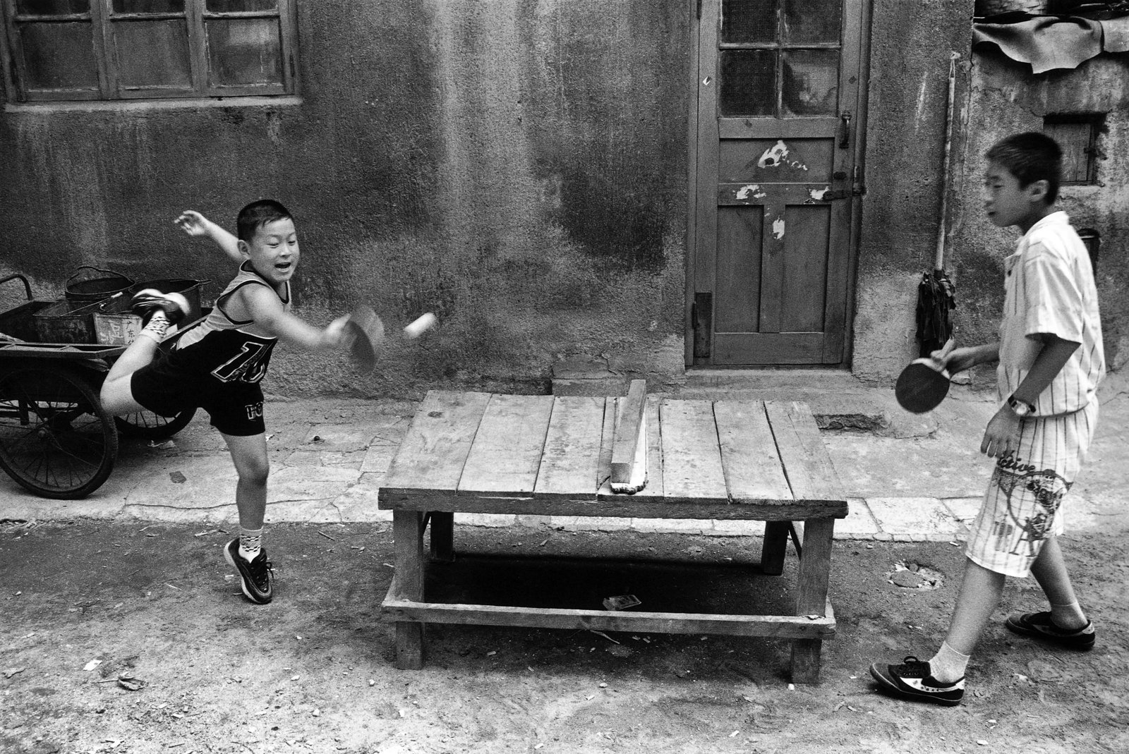 No. 10 Courtyard Series: Title: No. 10 Courtyard Series Series: Humanism in China, No. 477-1 Caption: Children Playing Table Tennis in the Courtyard Camera: Leica M6 with 35mm lens Medium: Digital giclee print Edition: 1/8 + 