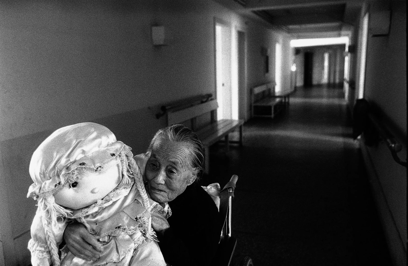 Humanism in China, No.226: Location: Jinan, Shandong Caption: In a retirement home, an elderly woman sits in a wheelchair, still insisting that she can help care for children. Medium: Digital giclee print This work was photogra