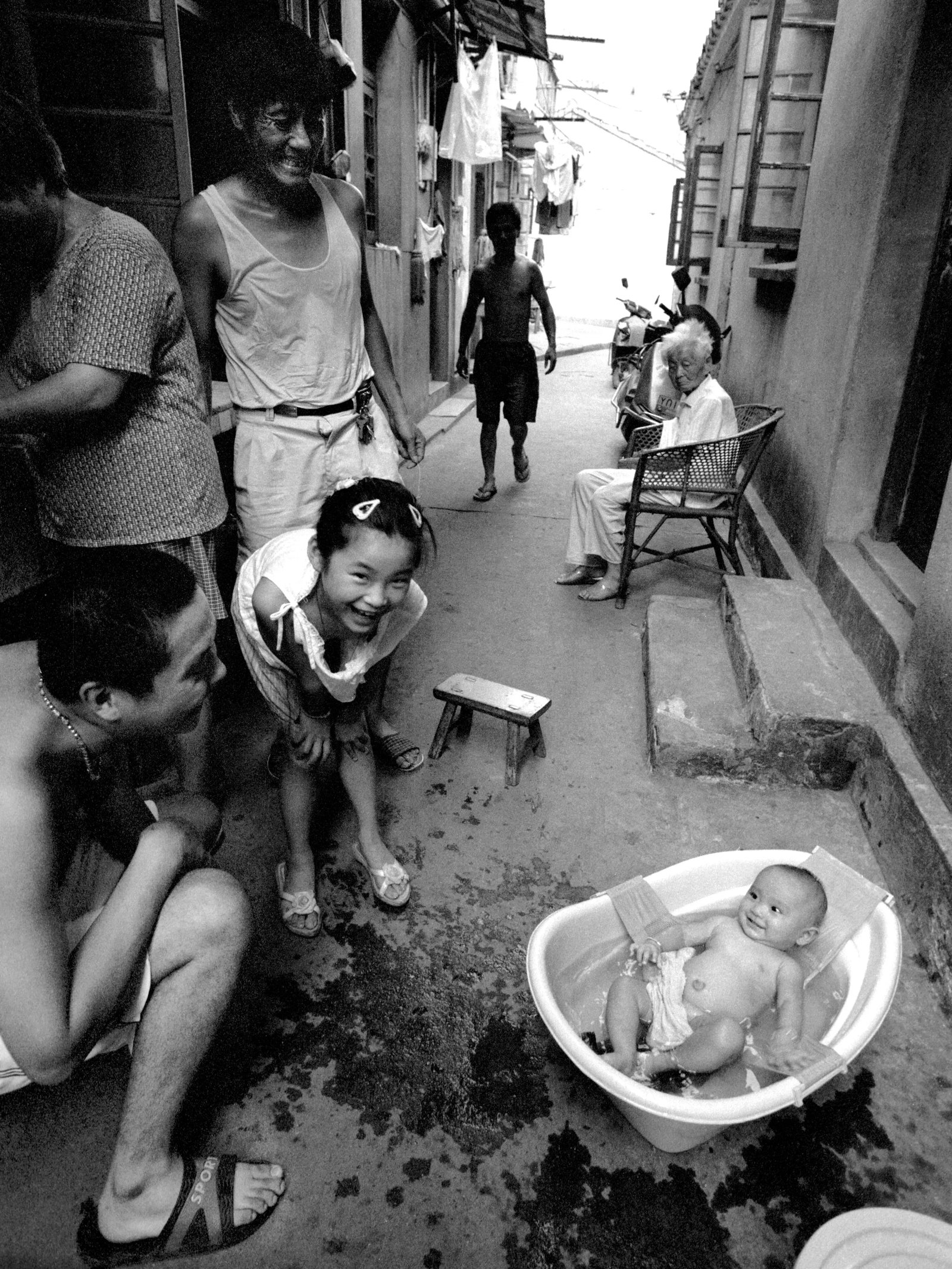 Cooling a Baby in an Old-Fashioned Way in Wuxi Old Town: Print Date: 2016 Series: Humanism in China, No. 128 Location: Changqing Road, Wuxi, Jiangsu Medium: Hahnemuhle 310gsm cotton matte fine art paper, giclee print Edition: 11/30 Signature: Signed by the 