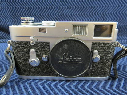 Vintage Leica M2 Camera Body: Cosmetically in nice shape, just the former owner name on affixed labels at the bottom, and some glue remnants from another label. From the estate of a former professional photographer, a note found w