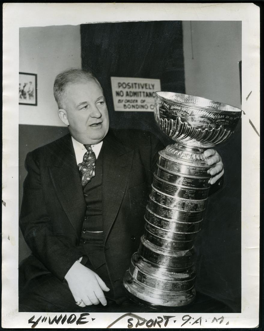 1937 Stanley Cup Hockey Original Photo: Jack Adams holds the Stanley Cup Trophy. Dated 3/15/37. 8 x 10. Very good.