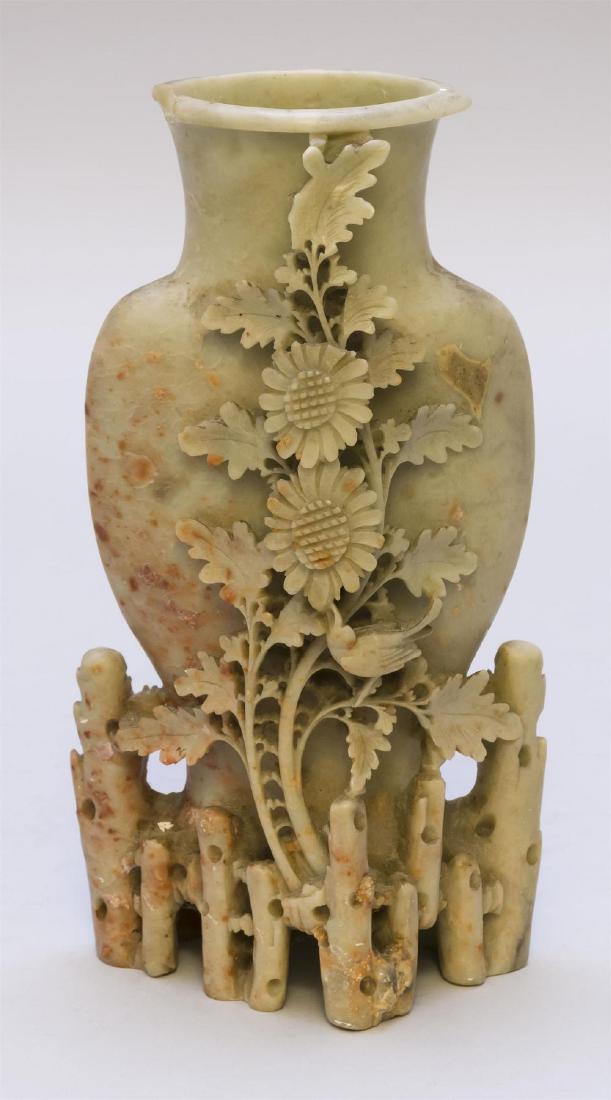 CHINESE CARVED MOTTLED SOAPSTONE VASE 20th Century: With applied floral decoration to body. Fence-form base. Height 8.5 inches. Â 1/2 inch chip to the mouth.