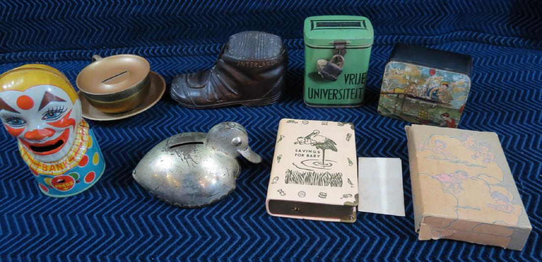 (7) Vintage and Antique Metal Still Banks: Lot of (7) pieces. Includes 1) Teacup. 2) Tin Litho Clown 3) Tin litho duck with movable bill (missing stopper on bottom) 4) Paper mache over lacquer box with beach scene. 5) Caved wood boot souvenir