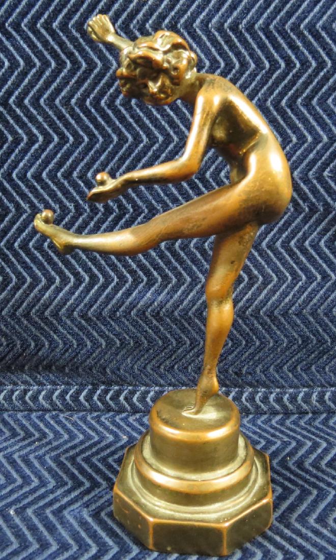 Antique Bronze Figure Nude Girl Kicking: 8 inches tall. A small ball is in each hand and one balances on her foot. No signature. Excellent condition.