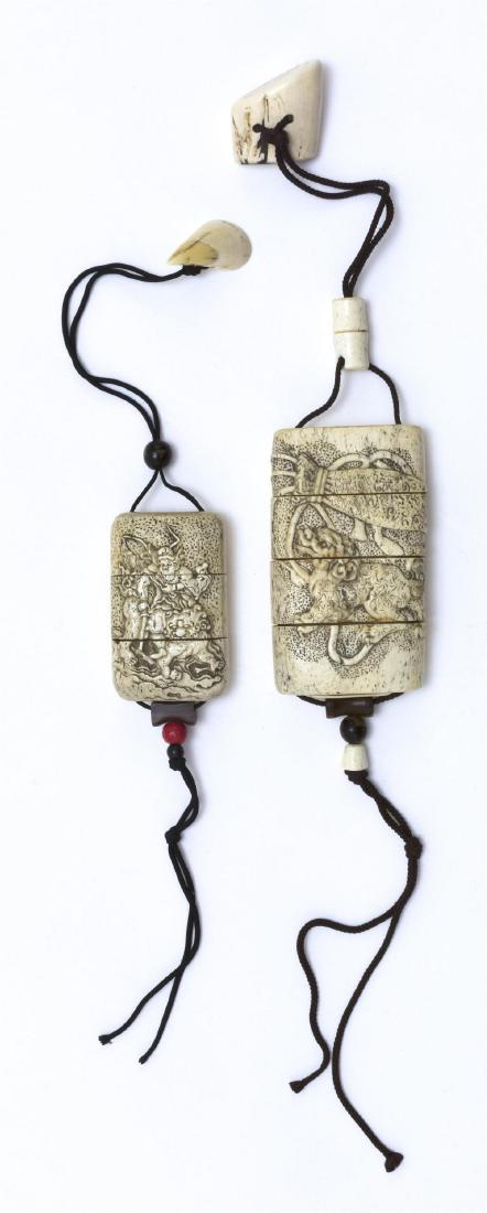 TWO JAPANESE CARVED ELK HORN INRO Late Meiji Period: 1) Four-case inro with relief fu dog and treasure sack design. Length 4.75 inches. Horn cross-section netsuke. Length 0.75 inches. 2) Three-case inro with relief shoki and shishi design. Length 3.5 in