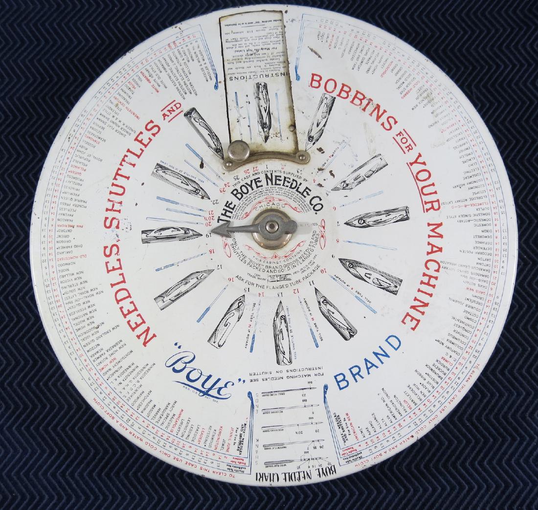 BOYE NEEDLE SINGER STORE DISPLAY TIN: Spin the dial to the type of needle that you need, open the window and the needle is there for you. Store display comes from an old sewing store in Hyannis MA, Cape Cod. 16 inches in diameter. 3 inche