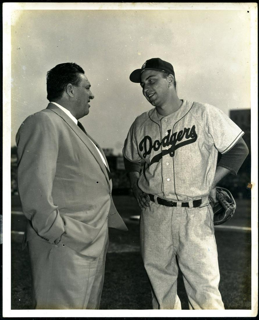 1950s Johnny Podres Dodgers Original 8 x 10 Photograph: Brooklyn Dodgers Johnny Podres talking to a film maker. Taken by photographer Miguel Luis of New York. A couple of small holes in the photo. Very Good.