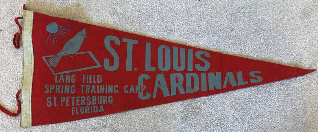 1950s ST. LOUIS CARDINALS Spring Training Full Size: This St. Louis Cardinals pennant measures 28.5 inches from side to side. The left hand side says, Lang Field-Spring Training Camp-St. Petersburg, Florida. Â This pennant Â is in very good conditio