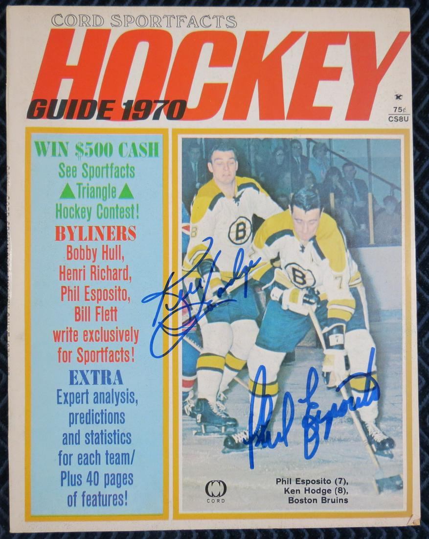 Phil Esposito and Ken Hodge Hockey Signed Magazine: 1970 Hockey Guide signed on the cover by Phil Esposito and Ken Hodge in mint blue sharpie. Magazine is EX-MT to NM. All signatures acquired in person at local New England card shows.