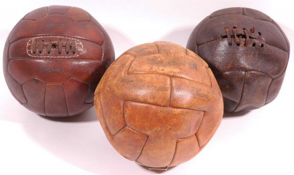 (3) Early Leather Soccer Balls: One lot of (3) early soccer balls. Two have laces, one has a leather bladder inside. The nicest is made by the Mark Cross Co, another is identified as "Tiger" and the third and lesser condition ball i