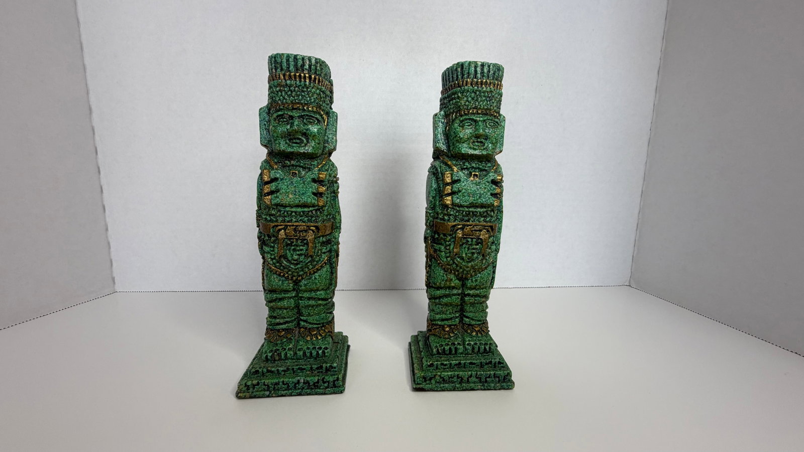 Stylized Mesoamerican/Andean Figure with Jade-Inspired Finish and Gilded Detailing: An evocative sculptural figure in the style of ancient Toltec, Olmec, or Inca ceremonial art, featuring a greenish patina with gilded detailing reminiscent of jade and turquoise inlays prized by pre-C