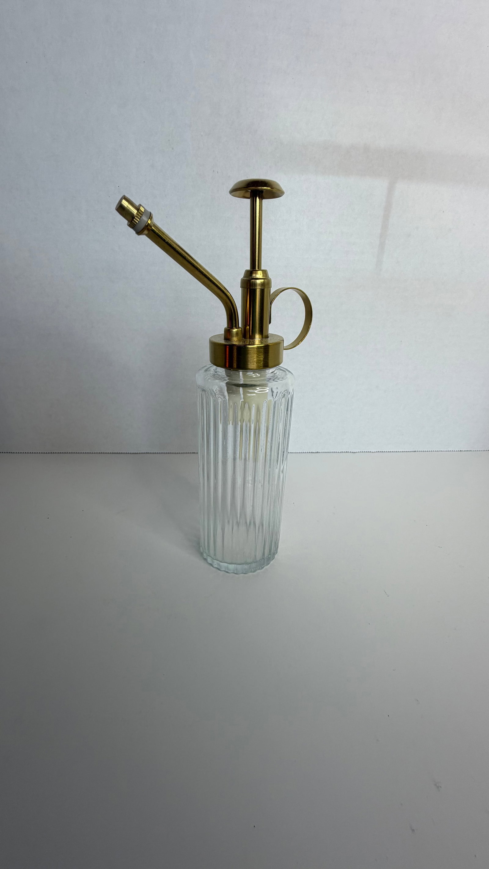 Vintage-Inspired Ribbed Glass Plant Mister with Gold-Tone Pump: A stylish and practical plant mister, blending form and function with vintage flair. The body is crafted from ribbed clear glass, offering a textured, apothecary-inspired look that reflects light beau