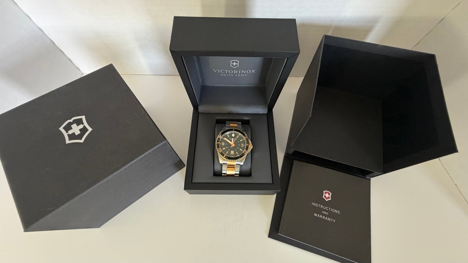 Victorinox Swiss Army Men's Watch – Two-Tone Stainless Steel | Black Dial | Original Box &: A stylish and robust Swiss-made timepiece from Victorinox, this Swiss Army watch blends utilitarian function with classic aesthetics. Featuring a two-tone stainless steel bracelet (silver and