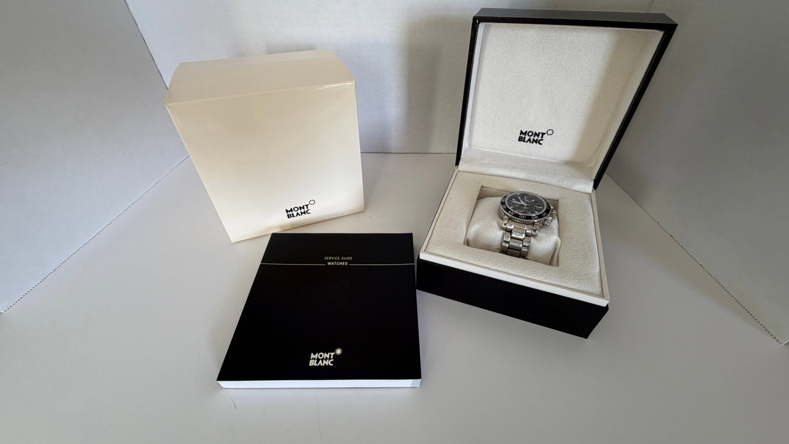 Montblanc Automatic Chronograph Stainless Steel Sport Watch – Full Set: An elegant and robust timepiece from the renowned house of Montblanc, this automatic chronograph combines Swiss precision with sporty sophistication. Featuring a deep black dial with luminous hands