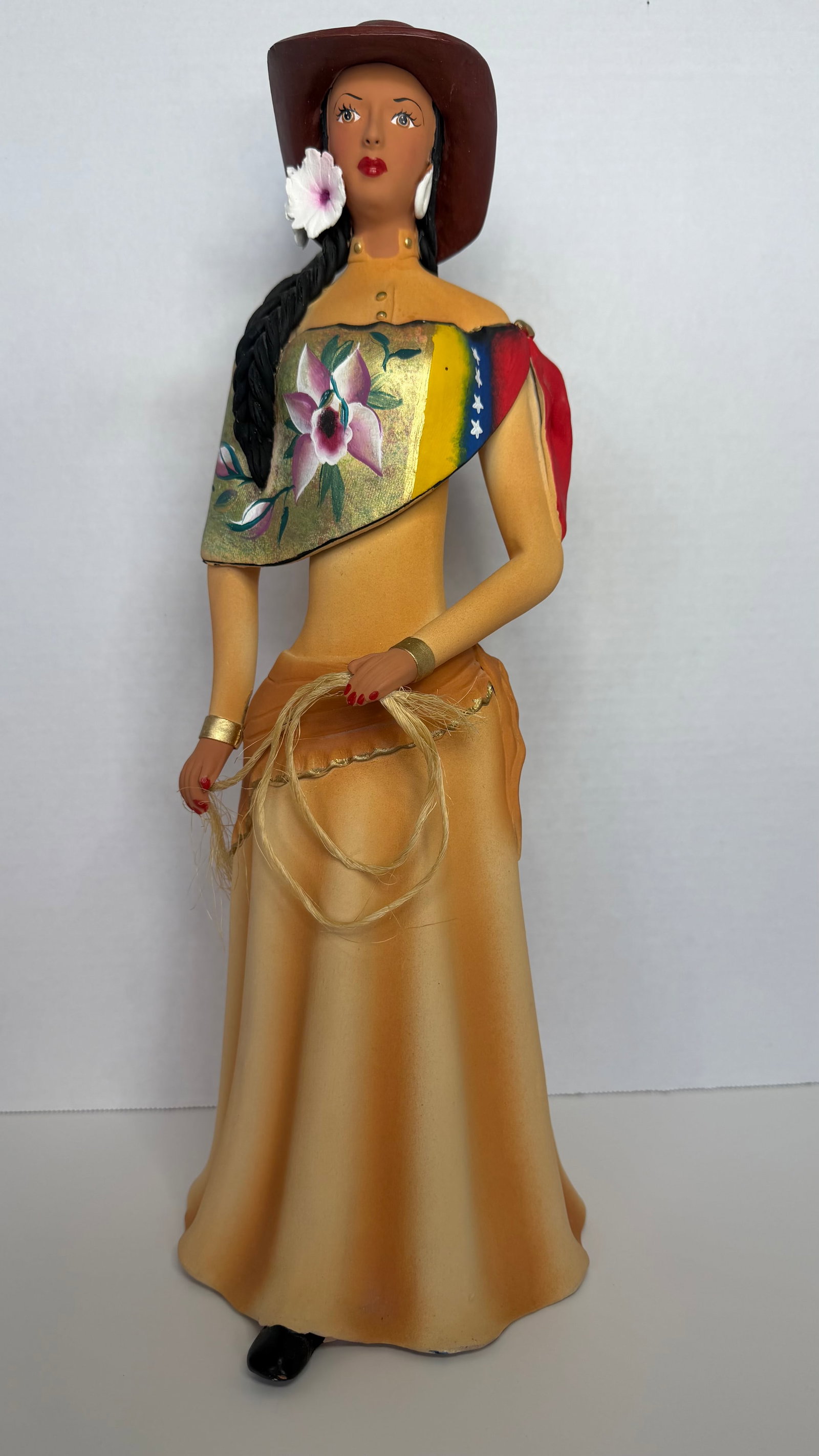 Handcrafted Ceramic Sculpture of a Venezuelan Llanera Woman: A beautifully handcrafted ceramic sculpture representing a traditional Venezuelan Llanera woman, rendered with striking detail and cultural authenticity. This vibrant figure stands with confident