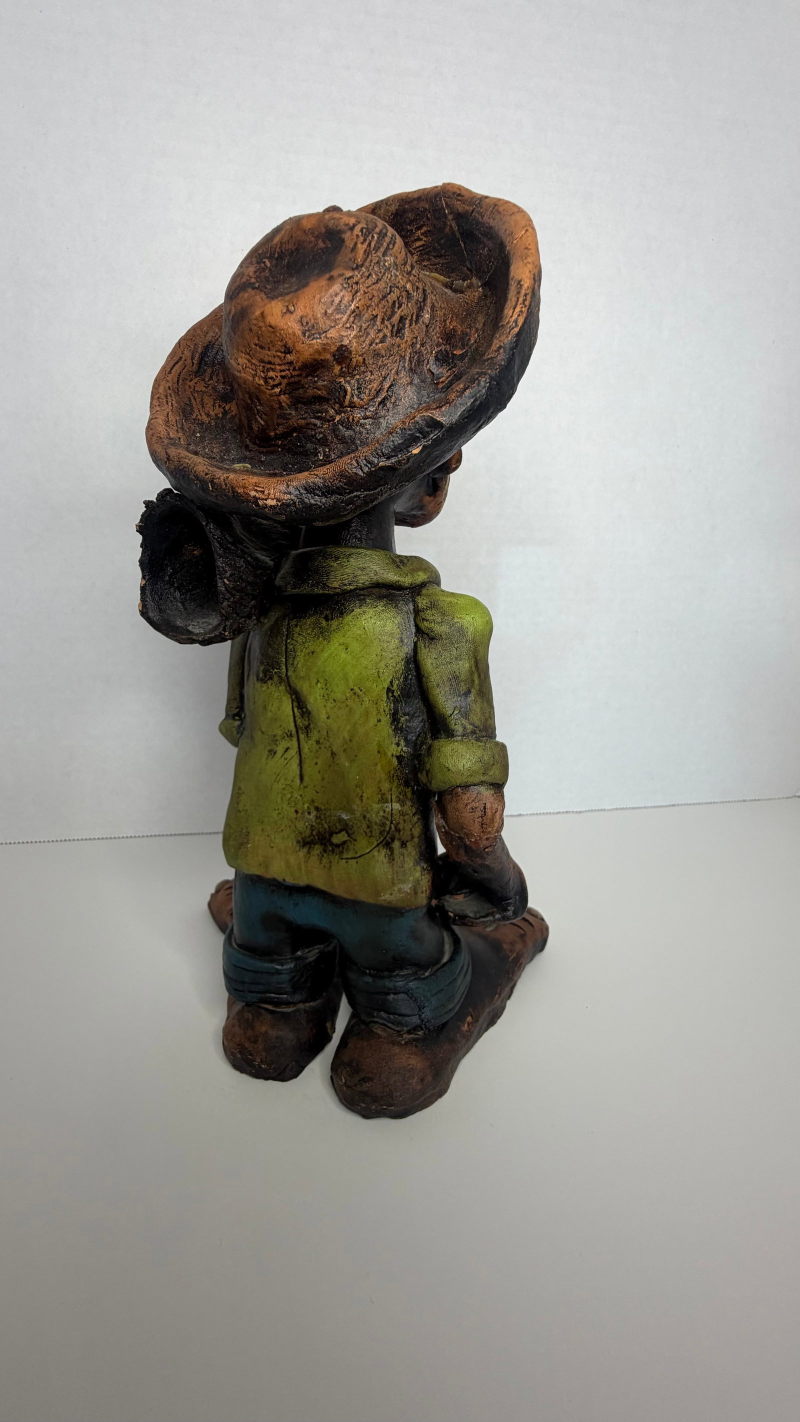 Caricature-Style Folk Art Figurine of a Brazilian Rural Worker: A whimsical and expressive handcrafted folk art figurine, portraying a Brazilian rural worker in classic caricature style. Crafted with playful exaggeration, the figure features oversized bare feet,