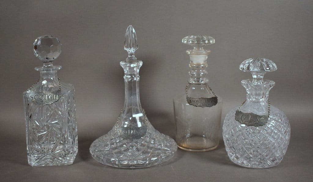 Four Glass Liquor Decanters with Stieff Pewter Name Tags: Largest is 12 H x 10 inches diameter. Please read “Terms of Sale” tab for preview, payment, pickup, shipping and other instructions. Lot includes the item(s) described in the title.