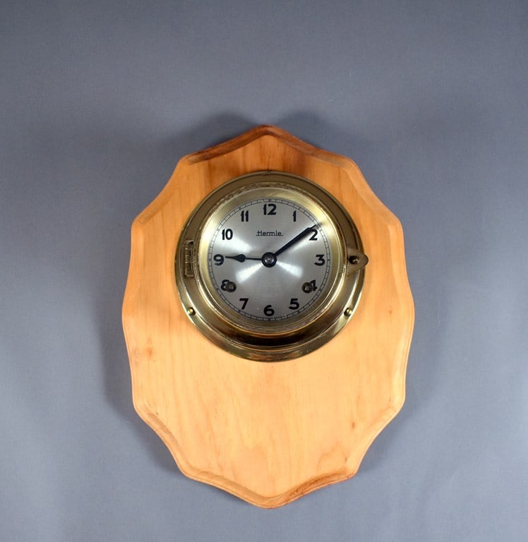 Vintage Mid-Century Hermle Nautical Ship's Clock, Germany: Clock is running. Diameter of clock is 6 inches. Size of wall plaque is 11 x 9 x 1 inch. Please read “Terms of Sale” tab for preview, payment, pickup, shipping and other instructions. Lot