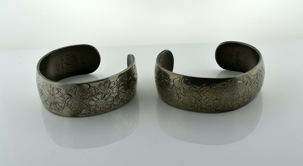 Pair of Kirk Engraved Pewter Cuff Bracelets, Aster & Violet: Please read “Auction Details” / “Terms of Sale” for preview, payment, pickup, shipping and other instructions. Lot includes the item(s) described in the title.