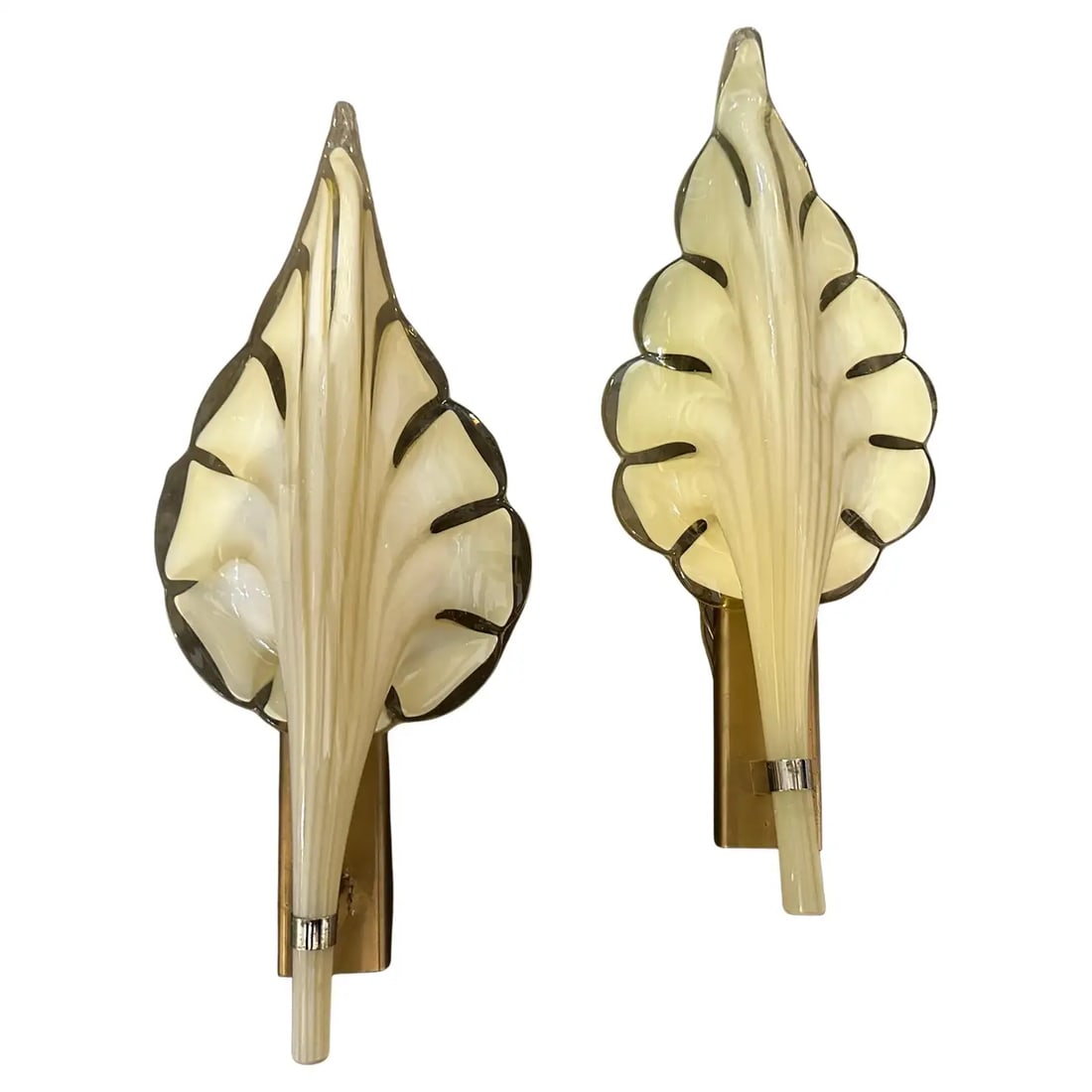 Two 1970s Mid-Century Modern Yellow Murano Glass Leaf Wall Sconce by Franco Luce: These are 1970s Mid-Century Modern murano glass wall sconces designed by Franco Luce. The sconces feature a striking leaf-shaped design made of hand-blown clear and Yellow Murano glass, with a translu
