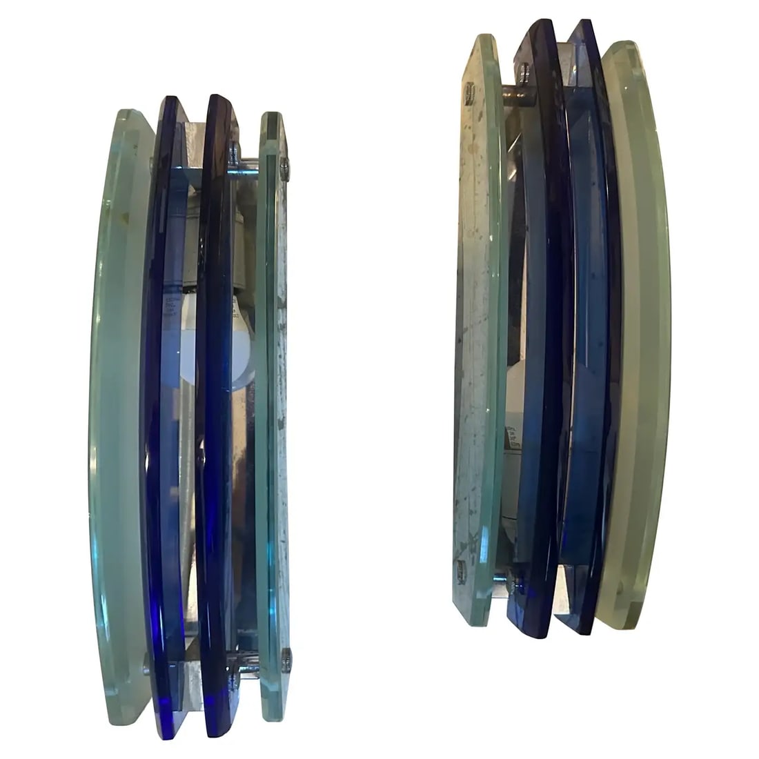 1960s Set of Two Space Age Blue Heavy Glass Italian Wall Sconces by Veca: Two amazing wall sconces, designed and manufactured in Italy by Veca during the Space Age era, are in very good condition and in working order. These wall sconces exhibit distinct design characteristi