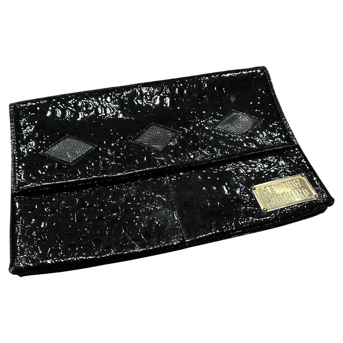 An Iconic Mi 1987 Clutch Bag by Franco Moschino: Own a piece of fashion history with this rare and highly collectible "Mi 1987" clutch bag, a quintessential creation from the visionary designer Franco Moschino. This iconic piece embodies the irrever